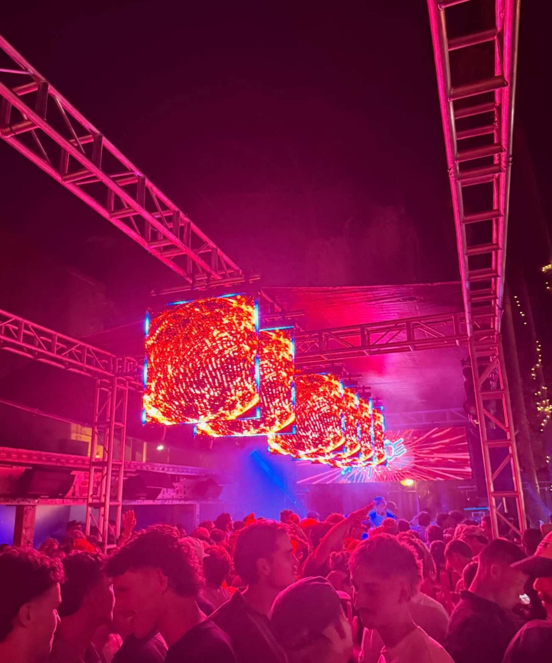 Suspended LED screen cubes above a crowd at a live event